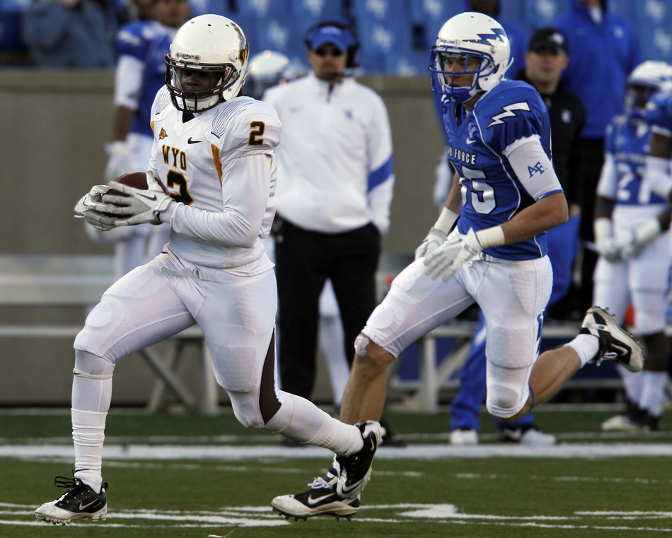 Wyoming cornerback Marqueston Huff (2) runs into the endzone in front of Air Force wide receiver Zack Kauth after a Huff recovered a muffed hook and ladder play in the closing minutes of a NCAA college football game on Saturday, Nov. 12, 2011, at Falcon Stadium in Colorado Springs, Colo.