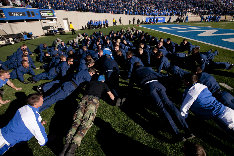 Air Force cadets do push ups after their team scored against Wyoming during a NCAA college football game on Saturday, Nov. 12, 2011, at Falcon Stadium in Colorado Springs, Colo.