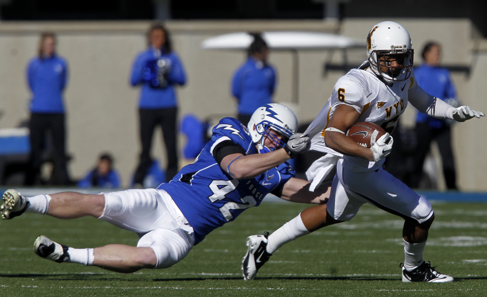 Air Force linebacker Austin Niklas (42) tries to bring down Wyoming wide receiver Robert Herron during a NCAA college football game on Saturday, Nov. 12, 2011, at Falcon Stadium in Colorado Springs, Colo.