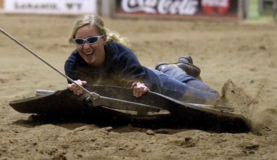 Katie Foust reacts as she's pulled on a rubber mat around an arena by a teammate during a practice of the LCCC Ranch Horse Team on Thursday, Nov. 17, 2011, at the LCCC. The team had a fun final practice of the year with light-hearted activities to close out their fall semester. LCCC will hold a fundraiser ranch rodeo on Dec. 10 and 11 at the school.