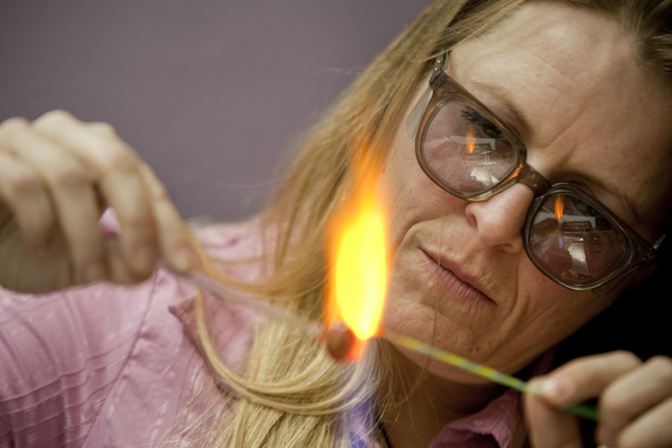 Shelley Girard works on a mushroom-shaped piece of glass under a flame during a glass-making demonstration on Thursday, Dec. 8, 2011, at The Ancient Sage in downtown Cheyenne. The glass making coincided with Cheyenne's Art Tour where 10 local businesses stayed open between 5 p.m. and 8 p.m. Thursday evening.