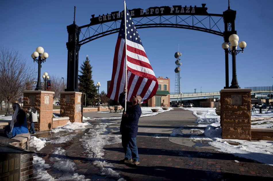 Gary Peterson of Cheyenne holds an American flag during an Occupy Cheyenne rally on Saturday, Dec. 10, 2011, at the Depot Plaza in Cheyenne.
