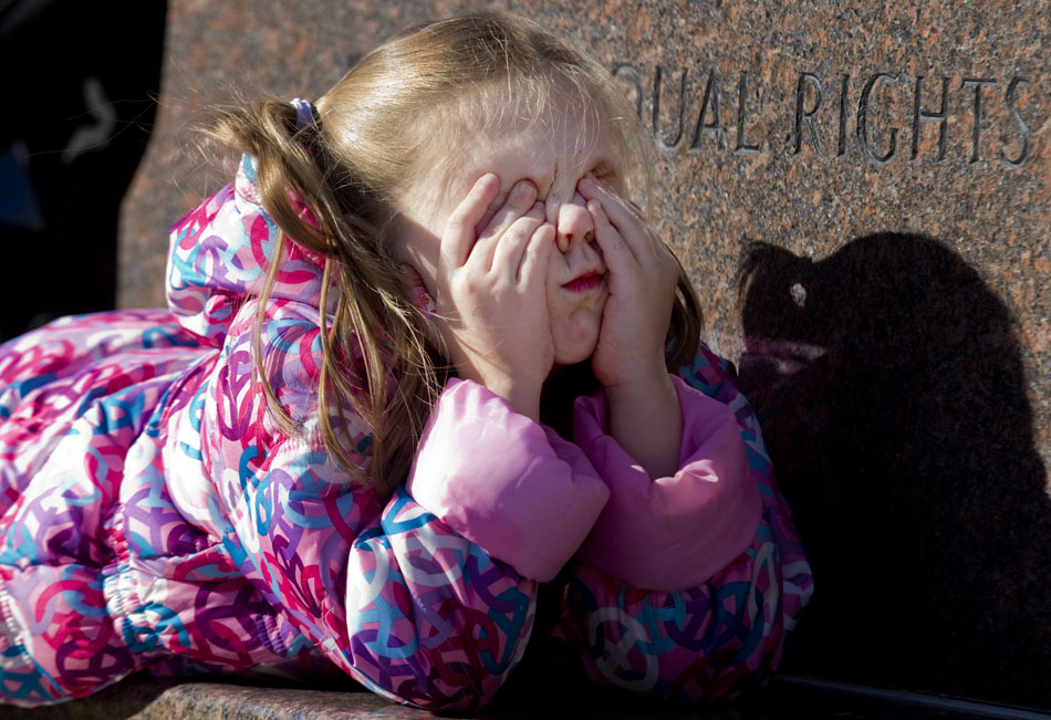 Piper Crawford, 4, wipes her eyes in boredom as she listens to speeches at an Occupy Cheyenne rally on Saturday, Dec. 10, 2011, at the Wyoming State Capitol. Crawford was at the rally with her parents, who recently moved to Cheyenne from Portland, Ore.