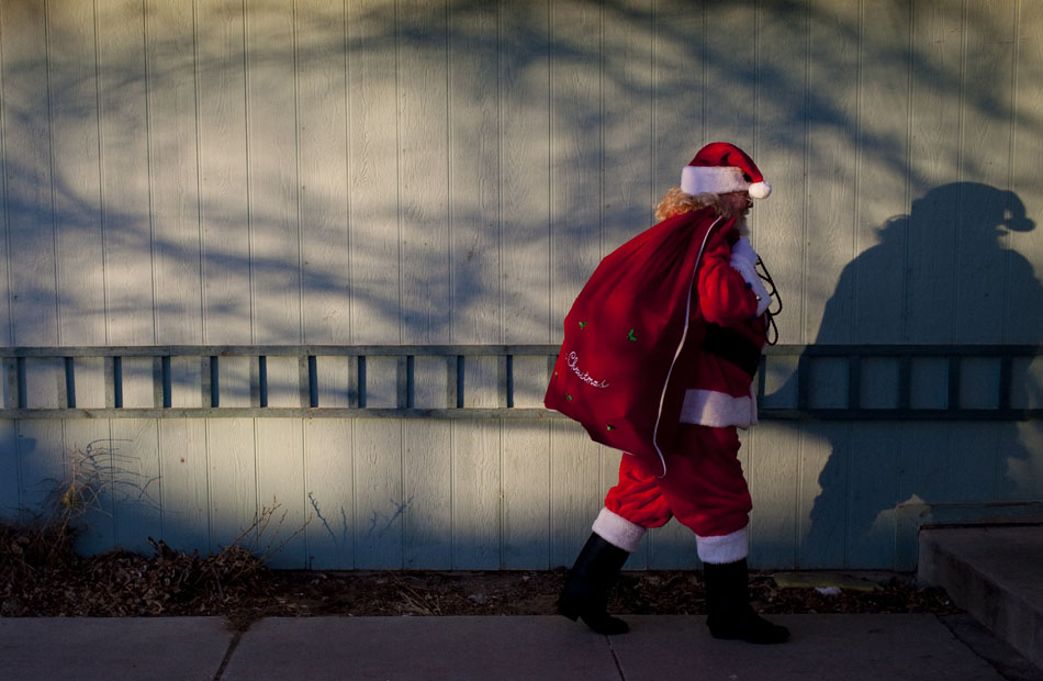 Santa Claus (Jack Coffey) carries a bag of toys to the home of the Pickens family on Thursday, Dec. 15, 2011, in south Cheyenne. Coffey surprised Collin Pickens, 4, and Jayden, 7, with donated toys following a Dec. 1 apartment fire that destroyed all of their belongings. The Cheyenne community raised $1,500 in cash and gift cards to donate to the family and Cheyenne Fire Local 279 bought toys with funding from its burn-out fund.