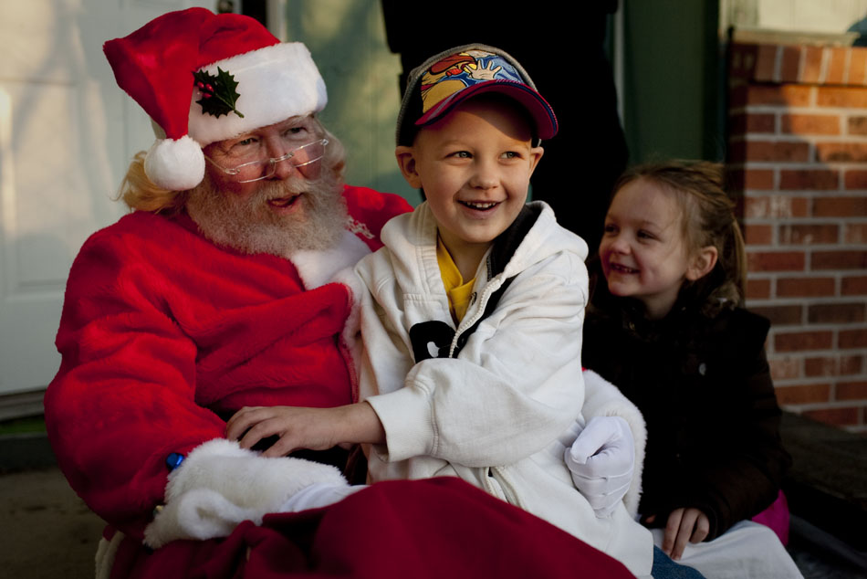 Collin Pickens, 4, reacts after he and his sister, Jayden, 7, came home from school to find Santa Claus (Jack Coffey) waiting on their doorstop on Thursday, Dec. 15, 2011, in south Cheyenne. Santa stopped by to drop off toys donated to the Pickens family following a Dec. 1 fire that destroyed their apartment. Members of the community donated $1,500 in cash and gift cards to the family and Cheyenne Fire Local 279 bought and wrapped toys.