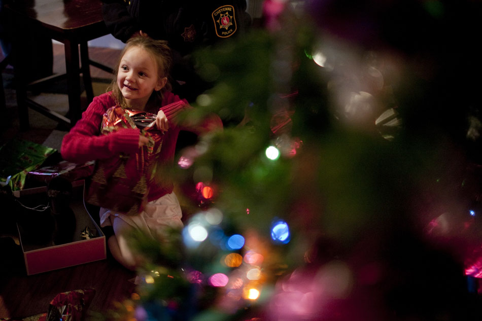 Jayden Pickens, 7, unwraps a toy during a visit from Santa Claus on Thursday, Dec. 15, 2011, in south Cheyenne. Santa stopped by to drop off toys donated to the Pickens family following a Dec. 1 fire that destroyed their apartment. Members of the community donated $1,500 in cash and gift cards to the family and Cheyenne Fire Local 279 bought and wrapped toys.