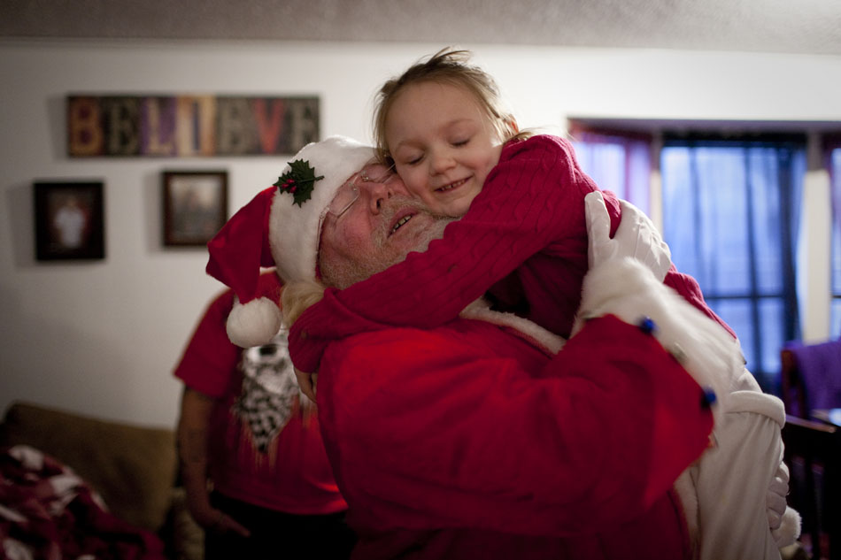 Jayden Pickens, 7, gives Santa Claus (Jack Coffey) a hug after unwrapping a few presents on Thursday, Dec. 15, 2011, in south Cheyenne. Santa stopped by to drop off toys donated to the Pickens family following a Dec. 1 fire that destroyed their apartment. Members of the community donated $1,500 in cash and gift cards to the family and Cheyenne Fire Local 279 bought and wrapped toys.