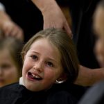Avery Bott, age 9, reacts as a hair dresser cuts a large lock of her hair off during a student assembly on Friday, Jan. 28, 2011, at Sunrise Elementary. Three students from the school donated their hair to the charity in honor of second grade teacher Heather Blakely-Voyles who has taken a leave of absence from teaching as she battles cancer. (James Brosher/Wyoming Tribune Eagle)