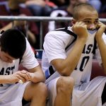 Cheyenne East's Derek Graves, right, watches from the bench with teammate Cameron Jaure during the closing minutes of a loss to Evanston in a Class 4A game in the state tournament fifth place bracket on Friday, March 11, 2011, in Casper, Wyo. (James Brosher/Wyoming Tribune Eagle)