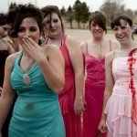 Cheyenne East students share a laugh before climbing into wrecked vehicles to portray victims at the scene of a fatal accident for a drunken driving crash demonstration on Tuesday, April 12, 2011, at Okie Blanchard Stadium in Cheyenne, Wyo. The demonstration coincides with East's prom on Saturday. (James Brosher/Wyoming Tribune Eagle)