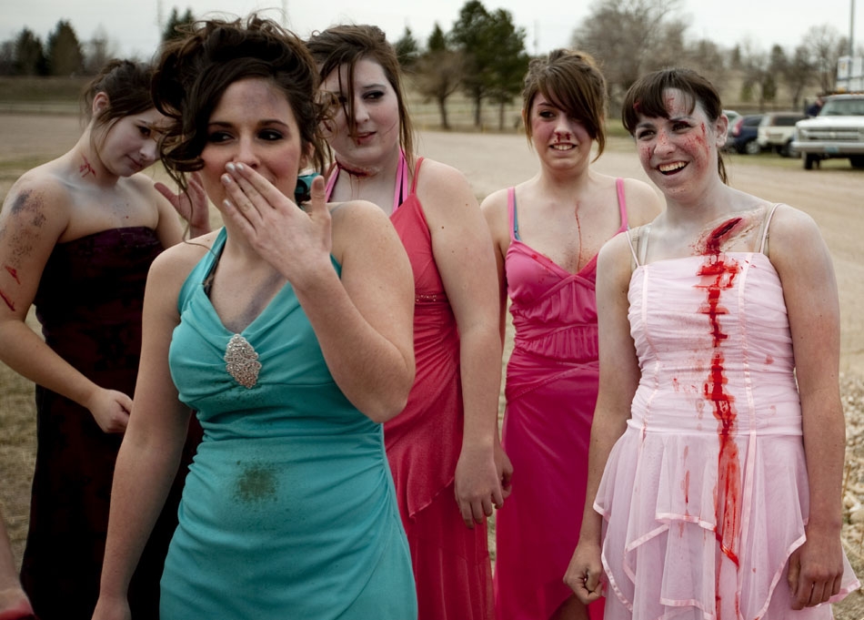 Cheyenne East students share a laugh before climbing into wrecked vehicles to portray victims at the scene of a fatal accident for a drunken driving crash demonstration on Tuesday, April 12, 2011, at Okie Blanchard Stadium in Cheyenne, Wyo. The demonstration coincides with East's prom on Saturday. (James Brosher/Wyoming Tribune Eagle)