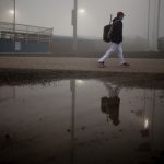 A Cheyenne Post 6 junior varsity player leaves Powers Field after the junior varsity game was called due to dense fog on Sunday, May 29, 2011, in Cheyenne. The fog blanketed the outfield making it hard to see pop ups, forcing officials to postpone a game between Cheyenne Post 6 and Ralston Valley until 9 a.m. on Monday. (James Brosher/Wyoming Tribune Eagle)