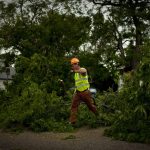 Edward Cullen, a City of Cheyenne employee, puts his arm up as he hops over a downed tree limb on Thursday, June 30, 2011, along House Avenue between Sixth and Seventh streets on the city's southeast side. Cheyenne spent part of the evening under a severe thunderstorm warning as rain and high winds swept across the area. (James Brosher/Wyoming Tribune Eagle)