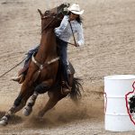 Sarah Kieckhefer from Prescott, Ariz. rounds the third barrel on her horse during the first go of barrel racing on Tuesday, July 19, 2011, at Frontier Park. Kieckhefer finished the run with a time of 18.71 seconds. (James Brosher/Wyoming Tribune Eagle)