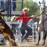 Matt Kenney from Onawa, Iowa hops off his horse and chases down a calf after he roped it during the first go of slack tie-down roping on Wednesday, July 20, 2011, at Frontier Park. (James Brosher/Wyoming Tribune Eagle)