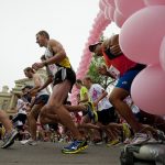 Under an arch made of pink balloons, runners leave the starting line for the Susan G. Komen Race for the Cure on Saturday, Aug. 13, 2011, in front of the Wyoming State Capitol. Laine Parish won the 5K with a time of 15:42.02. (James Brosher/Wyoming Tribune Eagle)