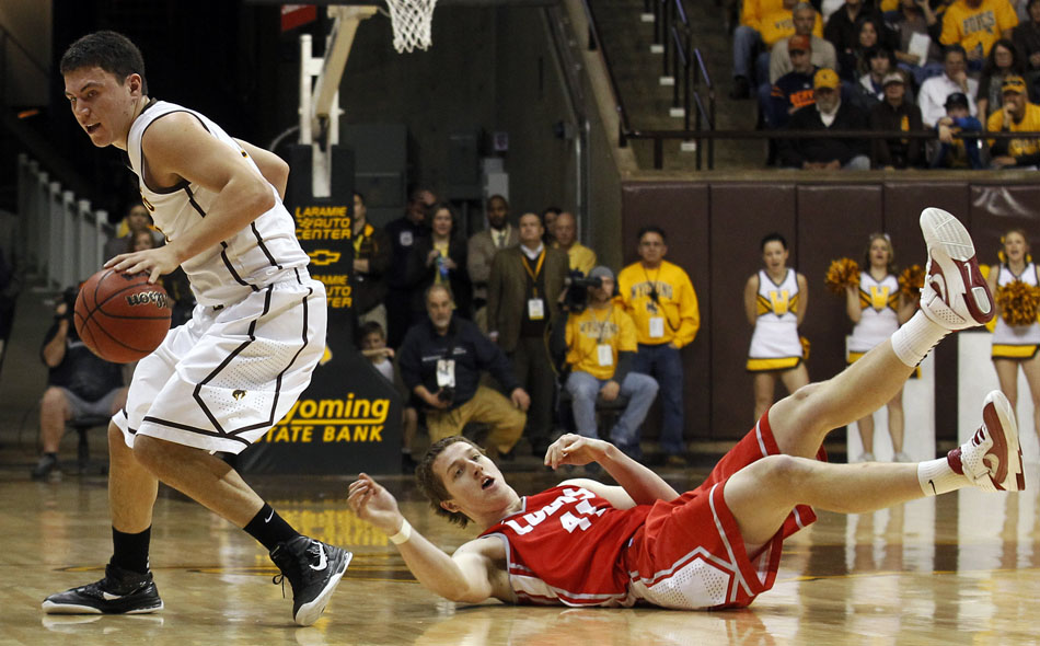 New Mexico forward Cameron Bairstow hits the court after committing a foul against Wyoming guard Francisco Cruz during a NCAA men's basketball game on Saturday, Jan. 14, 2012, at the Arena-Auditorium in Laramie, Wyo. Wyoming lost 72-62. (James Brosher/Wyoming Tribune Eagle)