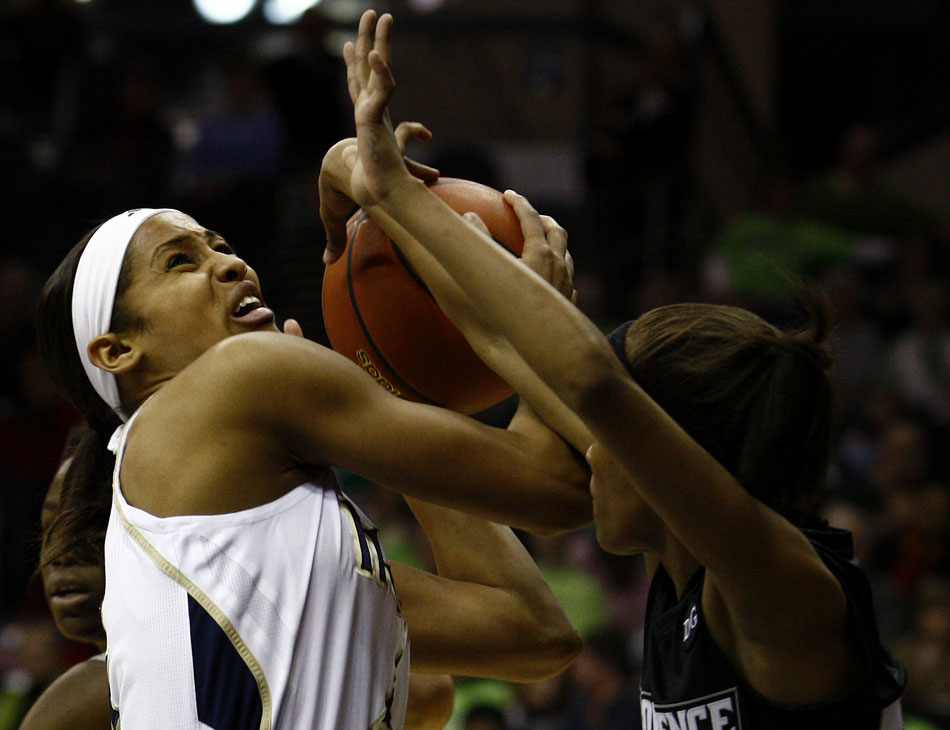 Notre Dame guard Skylar Diggins draws contact from Providence guard Symone Roberts during a women's NCAA college basketball game on Tuesday, Feb. 14, 2012, at Notre Dame. (James Brosher/South Bend Tribune)