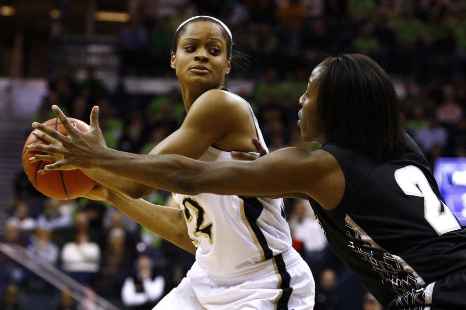 Notre Dame guard Fraderica Miller looks to pass as she's guarded by Providence forward Teya Wright during a women's NCAA college basketball game on Tuesday, Feb. 14, 2012, at Notre Dame. (James Brosher/South Bend Tribune)