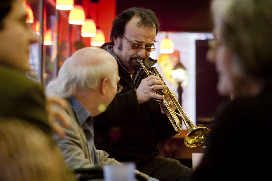 As patrons slip their coffee, Danny Barber plays a few jazz notes on the trumpet as he looks down at his playing partner, Jim Pickley, left, on piano on Tuesday, Feb. 21, 2012, at Chicory Cafe, a French Quarter-style coffee shop, in downtown South Bend. The two said they usually only perform at the cafe for Mardi Gras, and this year's performance was the third such occasion. "It's fun to do a duo," Barber said of the performance. "You just come in and play." (James Brosher/South Bend Tribune)