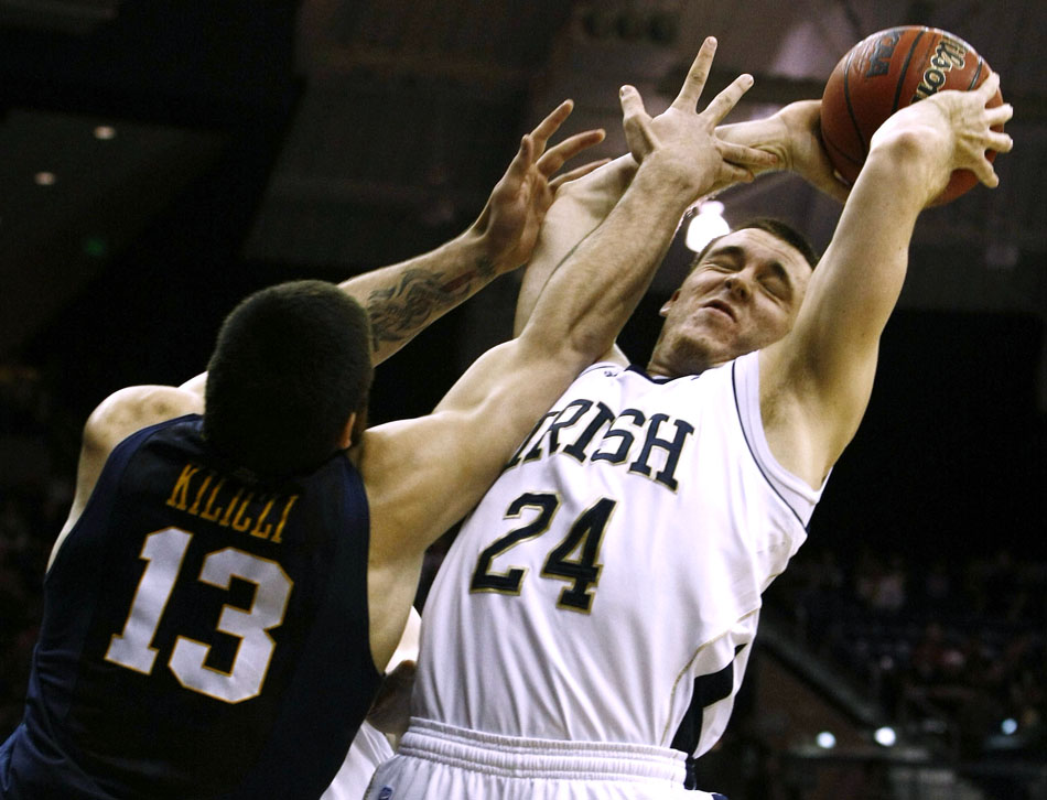 Notre Dame guard/forward Pat Connaughton grabs a rebound away from West Virginia forward Deniz Kilicli during a college basketball game on Wednesday, Feb. 22, 2012, at the Purcell Pavilion in South Bend. Notre Dame won 71-44. (James Brosher/South Bend Tribune)