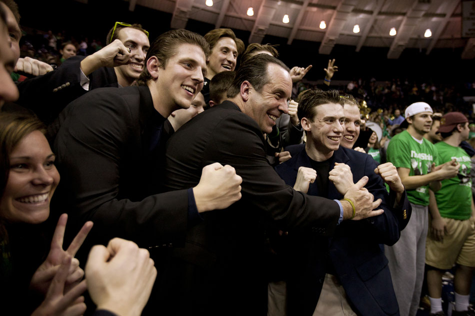 Notre Dame head coach Mike Brey poses with fans dressed as him in the Irish student section following a 71-44 win against West Virginia on Wednesday, Feb. 22, 2012, at the Purcell Pavilion in South Bend. (James Brosher/South Bend Tribune)