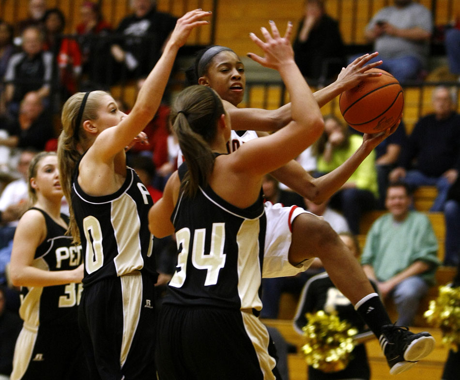 North Central's Celeste Edwards dices through the lane past Penn's Alex Morton and Tori Milliner (34) during the Class 4A girl's semi-state basketball game on Saturday, Feb. 25, 2012, at Warsaw High School. (James Brosher/South Bend Tribune)