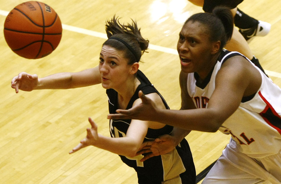 Penn's Caroline Buhr, left, and North Central's Nariah Taylor scramble for a loose ball during the Class 4A girl's semi-state basketball game on Saturday, Feb. 25, 2012, at Warsaw High School. (James Brosher/South Bend Tribune)