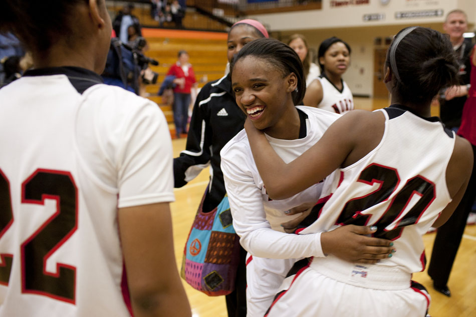North Central's Quintianna LeShore, center, celebrates a 65-50 win against Penn with teammates Shelbi Owens (20) and Erin Taylor after the Class 4A girl's semi-state basketball game on Saturday, Feb. 25, 2012, at Warsaw High School. (James Brosher/South Bend Tribune)