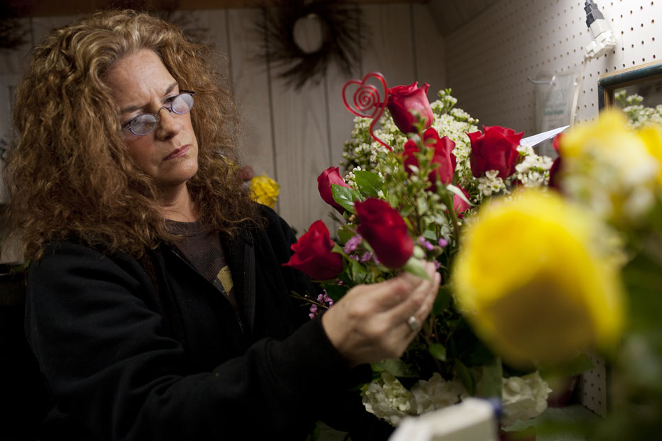 Armida Stauffer, of South Bend, puts the finishing touches on an arrangement of red roses on Monday, Feb. 13, 2012, at A Single Rose Florist, 118 S. Hill St. in South Bend. Stauffer, who has worked at the shop for about 24 years, had prepared about 25 arrangements on Tuesday morning for Valentine's Day. "When you've got nice flowers, it's fun to do," she said of the work. The shop owner, Rosemary Ponto Maurer, said the shop was expecting to fill 75 flower orders for the holiday this year. (James Brosher/South Bend Tribune)