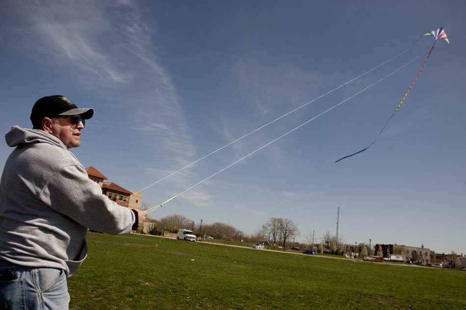 Chris Robbins flies a two-line stunt kite on a windy day on Wednesday, March 28, 2012, in Beutter Park near downtown Mishawaka. "My wife's careful not to tell me not to go fly a kite because she knows I will," he said. (James Brosher/South Bend Tribune)