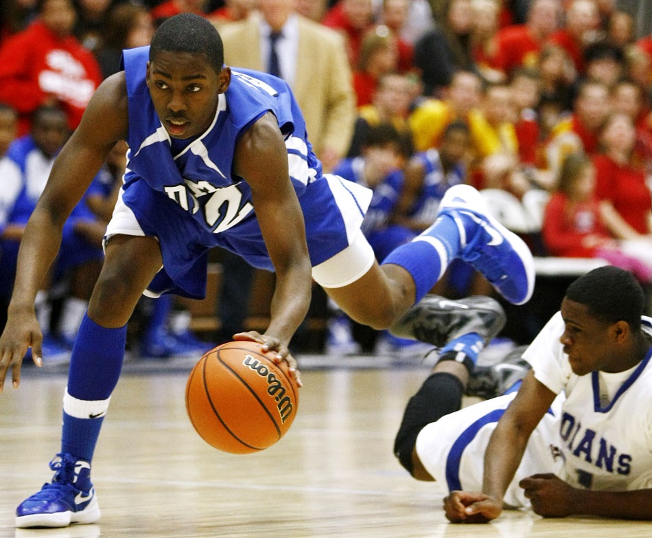 Adams' Juwan Johnson, left, corrals a loose ball after Lake Central's Tye Wilburn committed a turnover during a Class 4A basketball regional semi-final on Saturday, March 10, 2012, at Michigan City High School. (James Brosher/South Bend Tribune)