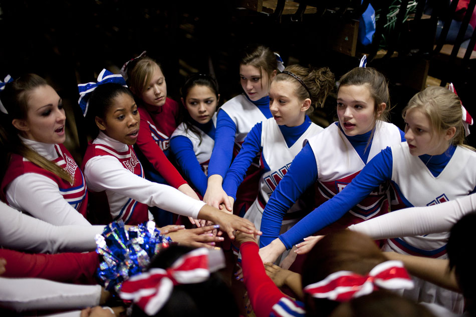 Adams cheerleaders huddle up before a Class 4A basketball regional semi-final against Lake Central on Saturday, March 10, 2012, at Michigan City High School. (James Brosher/South Bend Tribune)