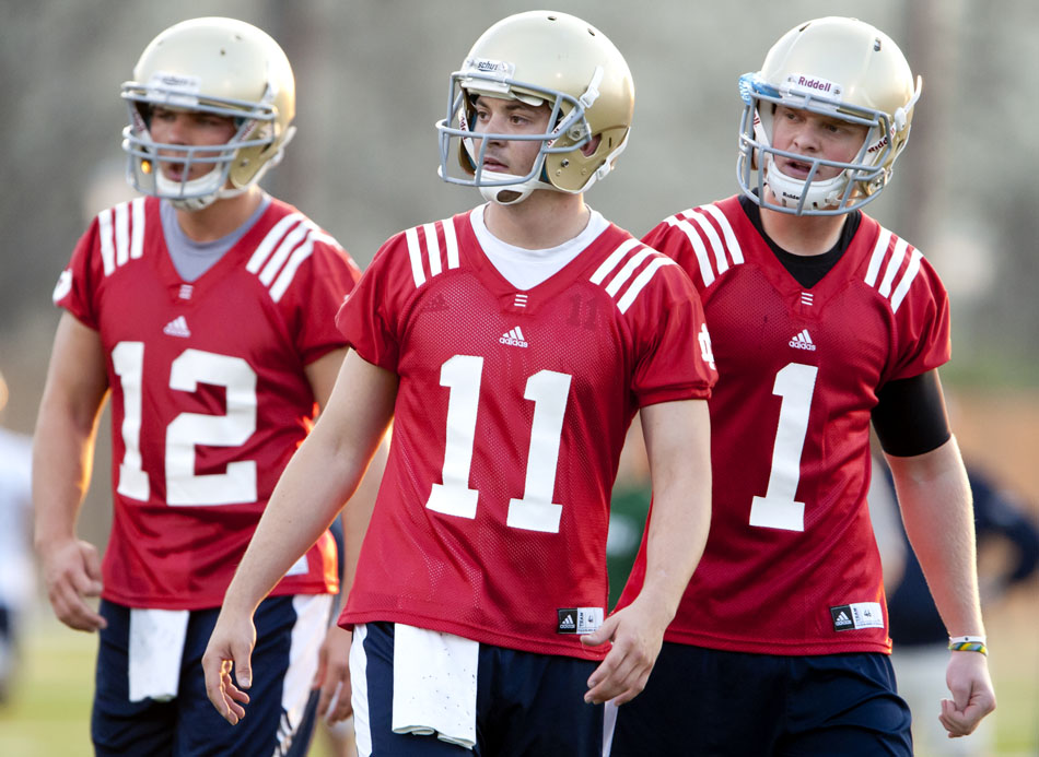 Notre Dame quarterbacks Tommy Rees (11), Andrew Hendrix (12) and Gunner Kiel (1) make their way onto the field for a spring football practice on Wednesday, March 21, 2012, at the LaBar practice fields. (James Brosher/South Bend Tribune)