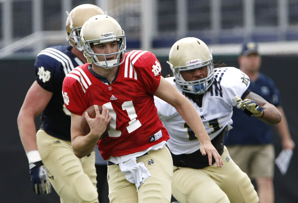 Notre Dame quarterback Tommy Rees takes off on a run during a spring football practice on Saturday, March 24, 2012, at the LaBar practice fields. (James Brosher/South Bend Tribune)