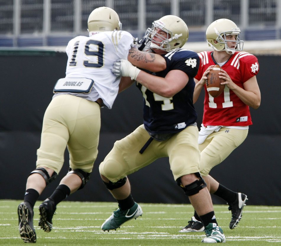 Notre Dame quarterback Tommy Rees looks to pass as he gets protection from guard Christian Lombard (74) during a spring football practice on Saturday, March 24, 2012, at the LaBar practice fields. (James Brosher/South Bend Tribune)