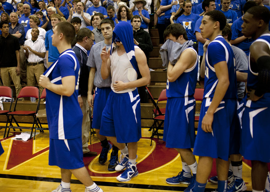 Mishawaka Marian's Michael Whitfield, center, reacts after a 76-67 loss to Norwell in a Class 3A semistate on Saturday, March 17, 2012, at Huntington North High School in Huntington, Ind. (James Brosher/South Bend Tribune)