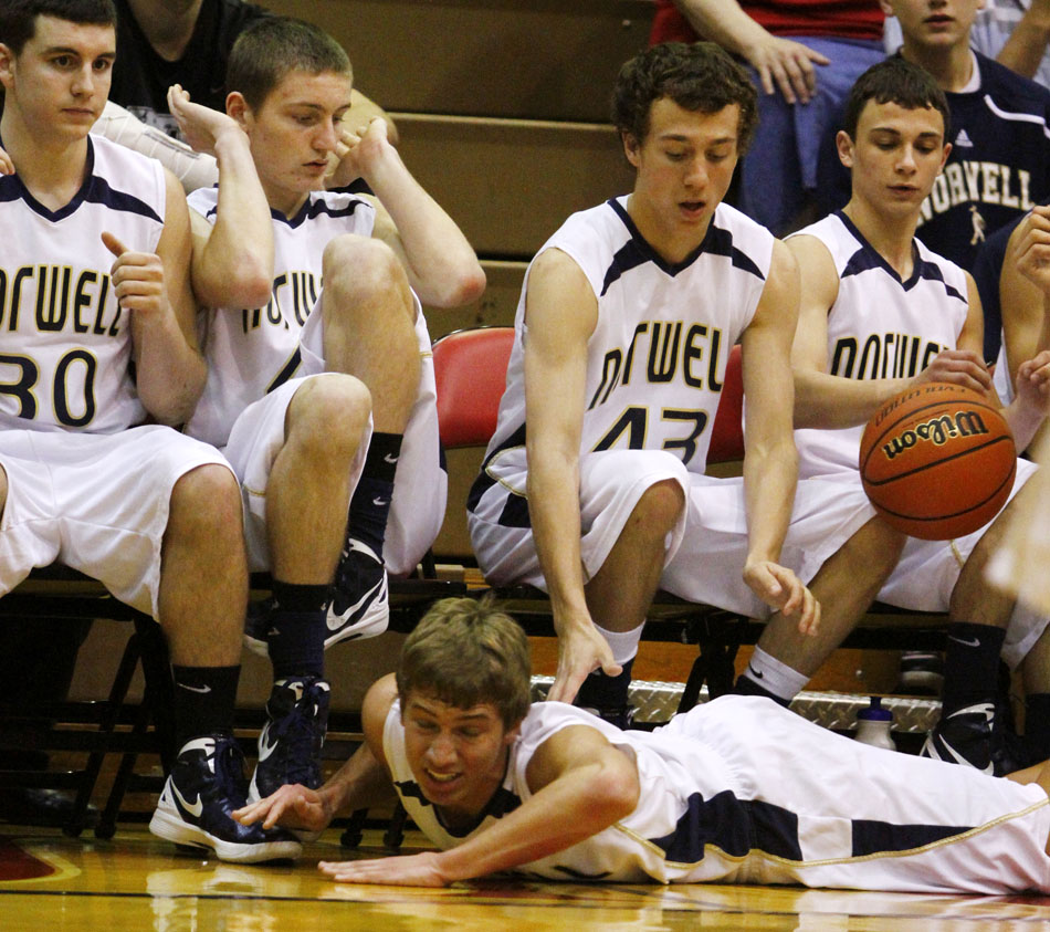 Norwell players react as teammate Caleb Featherston hits the floor as he goes after a loose ball during a Class 3A semistate on Saturday, March 17, 2012, at Huntington North High School in Huntington, Ind. (James Brosher/South Bend Tribune)