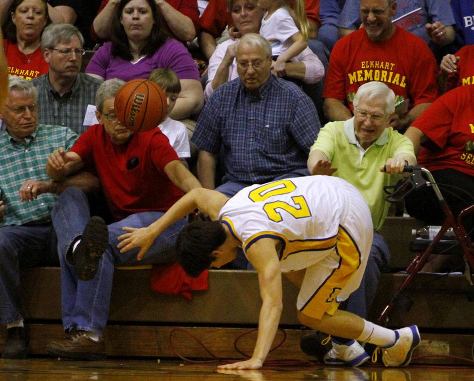 Carmel's James Volovic braces himself as he almost slides into spectators as he goes for a loose ball during a Class 4A semistate on Saturday, March 17, 2012, at Huntington North High School in Huntington, Ind. (James Brosher/South Bend Tribune)