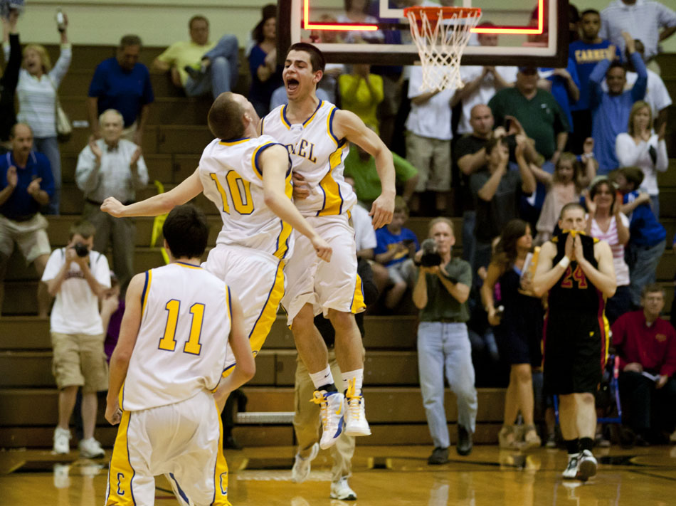 Carmel's Michael Volovic and James Crowley (10) celebrate as the final buzzer sounds in a 62-59 win against Elkhart Memorial in a Class 4A semistate on Saturday, March 17, 2012, at Huntington North High School in Huntington, Ind. (James Brosher/South Bend Tribune)