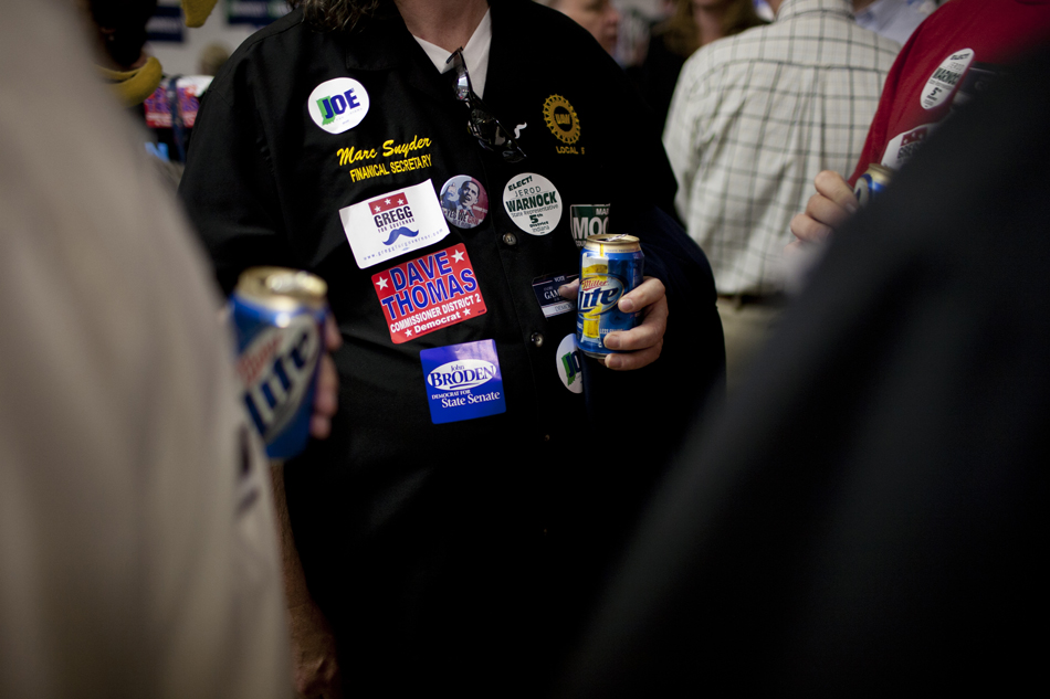 Supporters wear stickers for Democratic candidates as they enjoy beverages during Dyngus Day on Monday, April 9, 2012, at the West Side Democratic Club in South Bend.