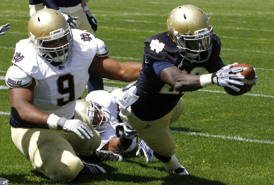 Notre Dame running back Cierre Wood dives for the end zone in front of nose tackle Louis Nix III during the Notre Dame Blue Gold game on Saturday, April 21, 2012, at Notre Dame. (James Brosher/South Bend Tribune)