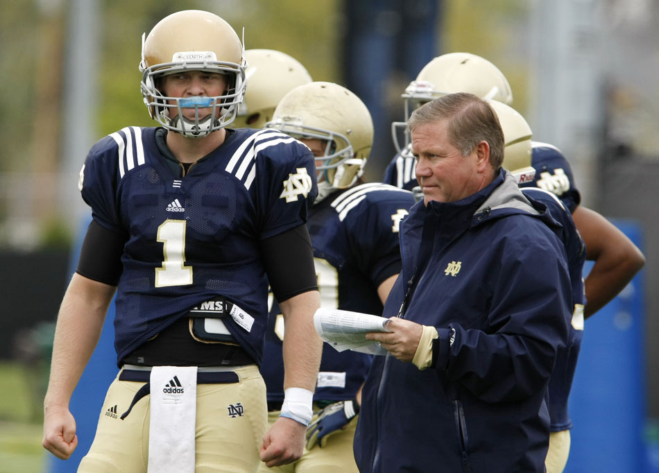 Notre Dame quarterback Gunner Kiel (1) watches from the sidelines with coach Brian Kelly during a football practice on Saturday, April 14, 2012, at Notre Dame. (James Brosher/South Bend Tribune)