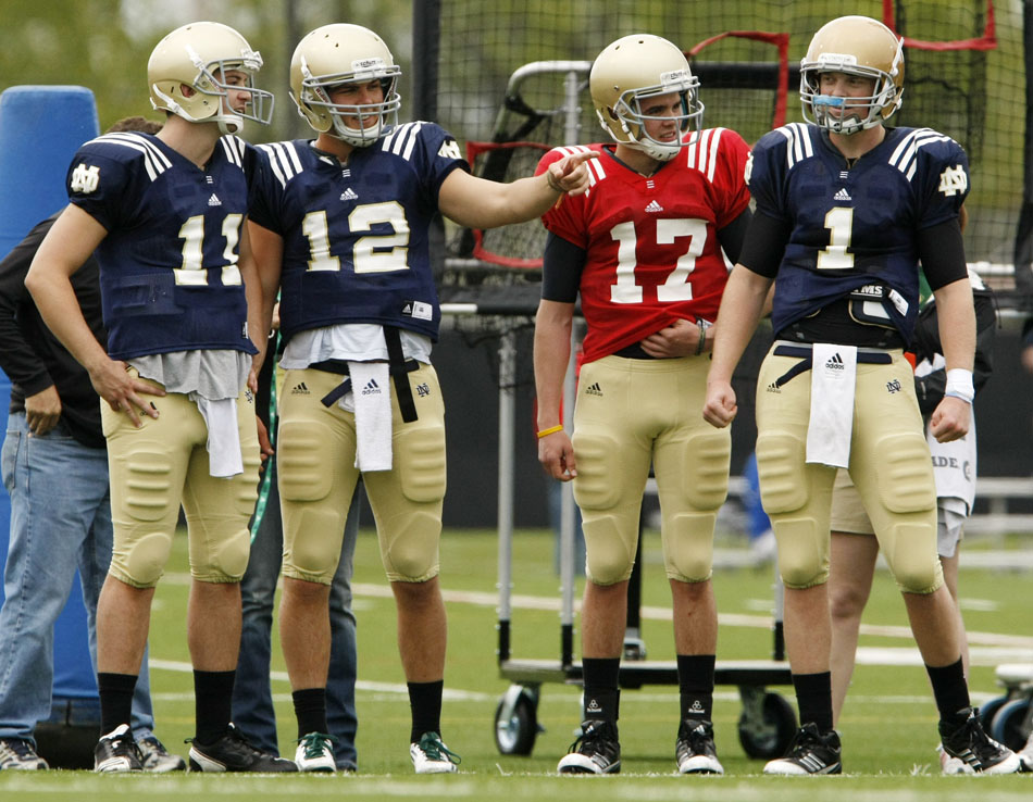 Notre Dame quarterbacks Tommy Rees (11), Andrew Hendrix (12), Charlie Fiessinger (17) and Gunner Kiel (1) watch the action from the sidelines during a football practice on Saturday, April 14, 2012, at Notre Dame. (James Brosher/South Bend Tribune)
