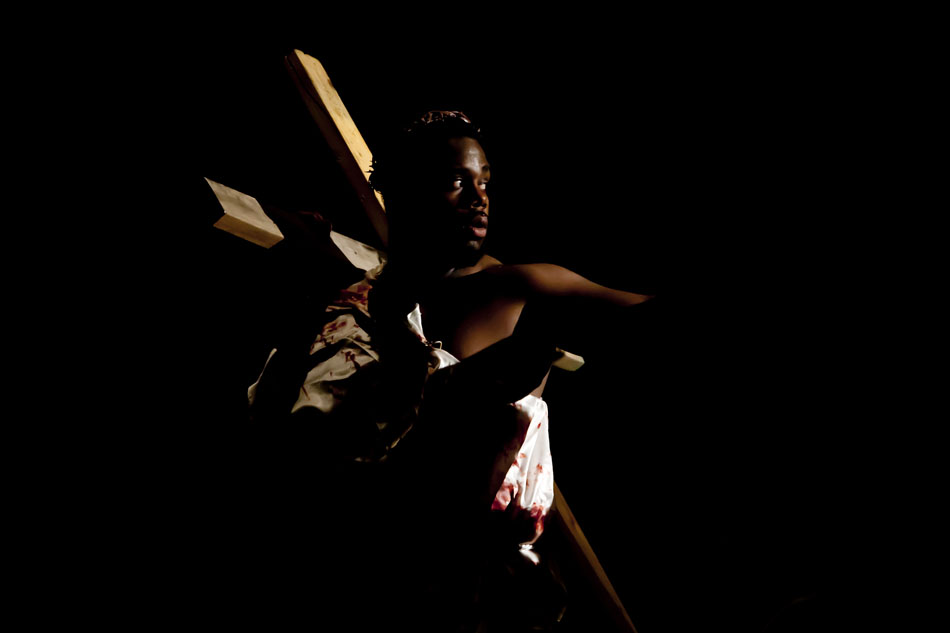 Jesus, played by Edward Denny IV, bares the cross on the way to his crucifixion during the performance of "I Am He" on Friday, April 6, 2012, at Washington High School in South Bend. (James Brosher/South Bend Tribune)