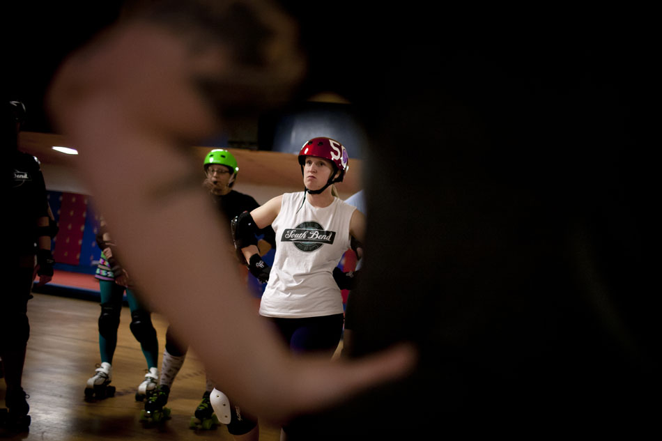 Genevieve Carlson, "Genevicious," listens to coaching during South Bend Roller Girls practice on Thursday, April 12, 2012, at USA Skate Center in Mishawaka. Carlson, who lives in South Bend, is an outreach coordinator for the Humane Society of St. Joseph County. (James Brosher/South Bend Tribune)