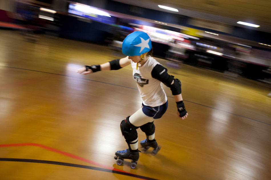 Candice Mansfield, "Candi-Land Massacre," makes her way through a turn as she takes part in a drill as a jammer during South Bend Roller Girls practice on Thursday, April 12, 2012, at USA Skate Center in Mishawaka. In roller derby, the jammer is the only person who can score points. Jammers, who wear stars on their helmets, get a point for each opponent passed during passes through the pack. Mansfield is a debt collector away from the rink. (James Brosher/South Bend Tribune)