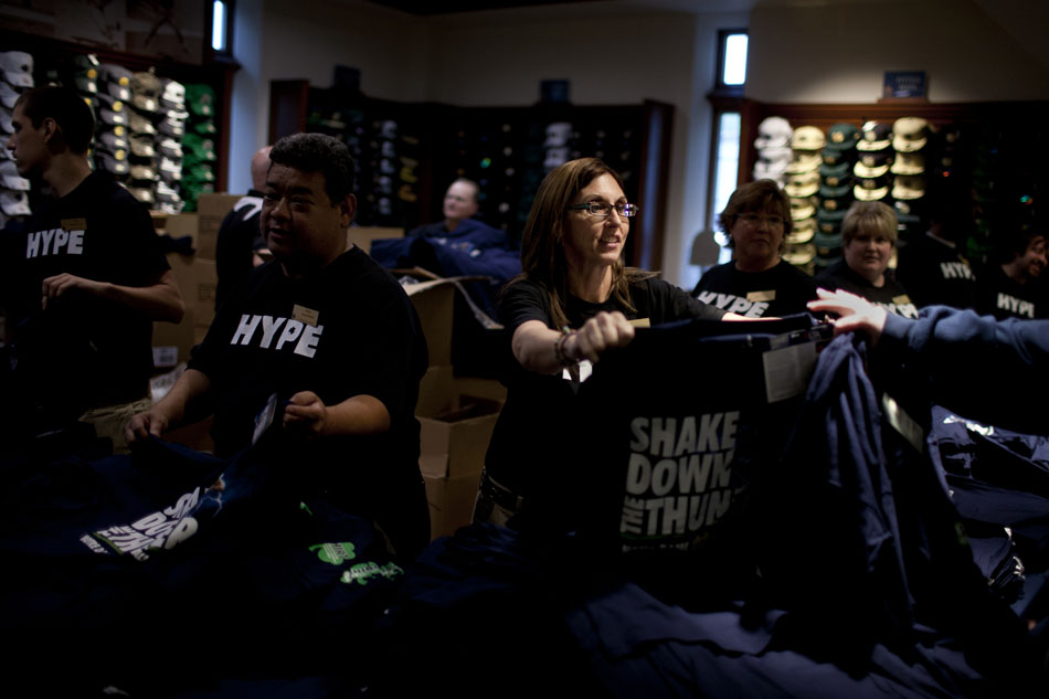 A bookstore employee hands out a t-shirt to a patron after an unveiling ceremony for The Shirt 2012 on Friday, April 20, 2012, at the Hammes Bookstore at Notre Dame. (James Brosher/South Bend Tribune)
