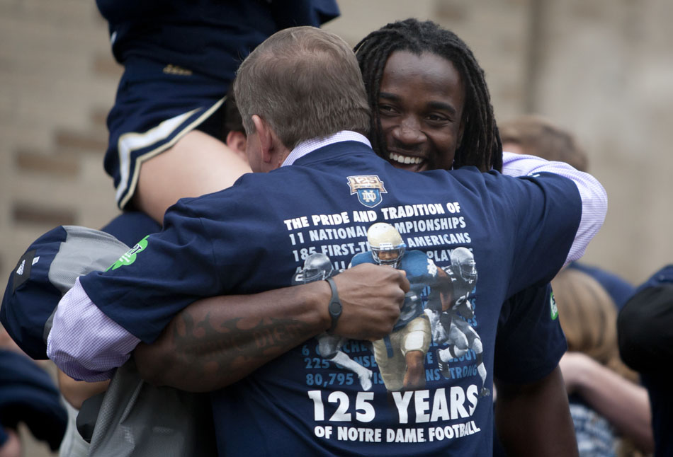 Former Notre Dame running back Robert Hughes hugs coach Brian Kelly during an unveiling ceremony for The Shirt 2012 on Friday, April 20, 2012, at the Hammes Bookstore at Notre Dame. (James Brosher/South Bend Tribune)