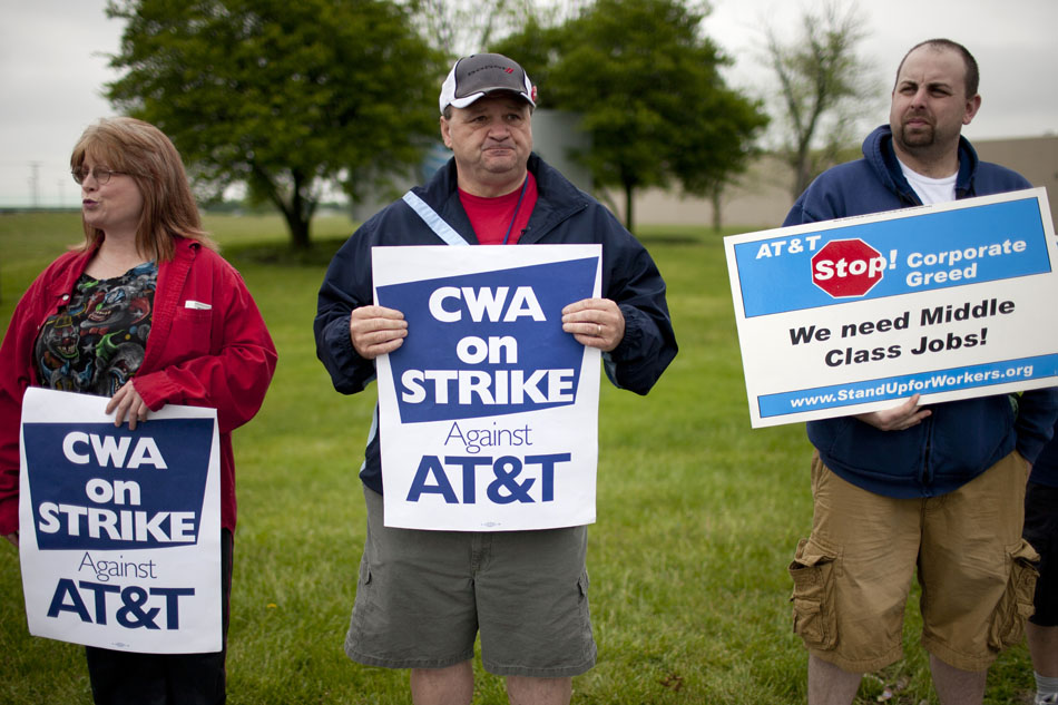 Jennifer Girten, left, Bob Makin and Jeremy Bishop, hold signs during a Communication Workers of American Local 4900 solidarity strike against AT&T on Monday, May 7, 2012, outside of the AT&T warehouse on Cleveland Road. The strike was to show support for a grievance strike in Anderson, Ind. (James Brosher/South Bend Tribune)